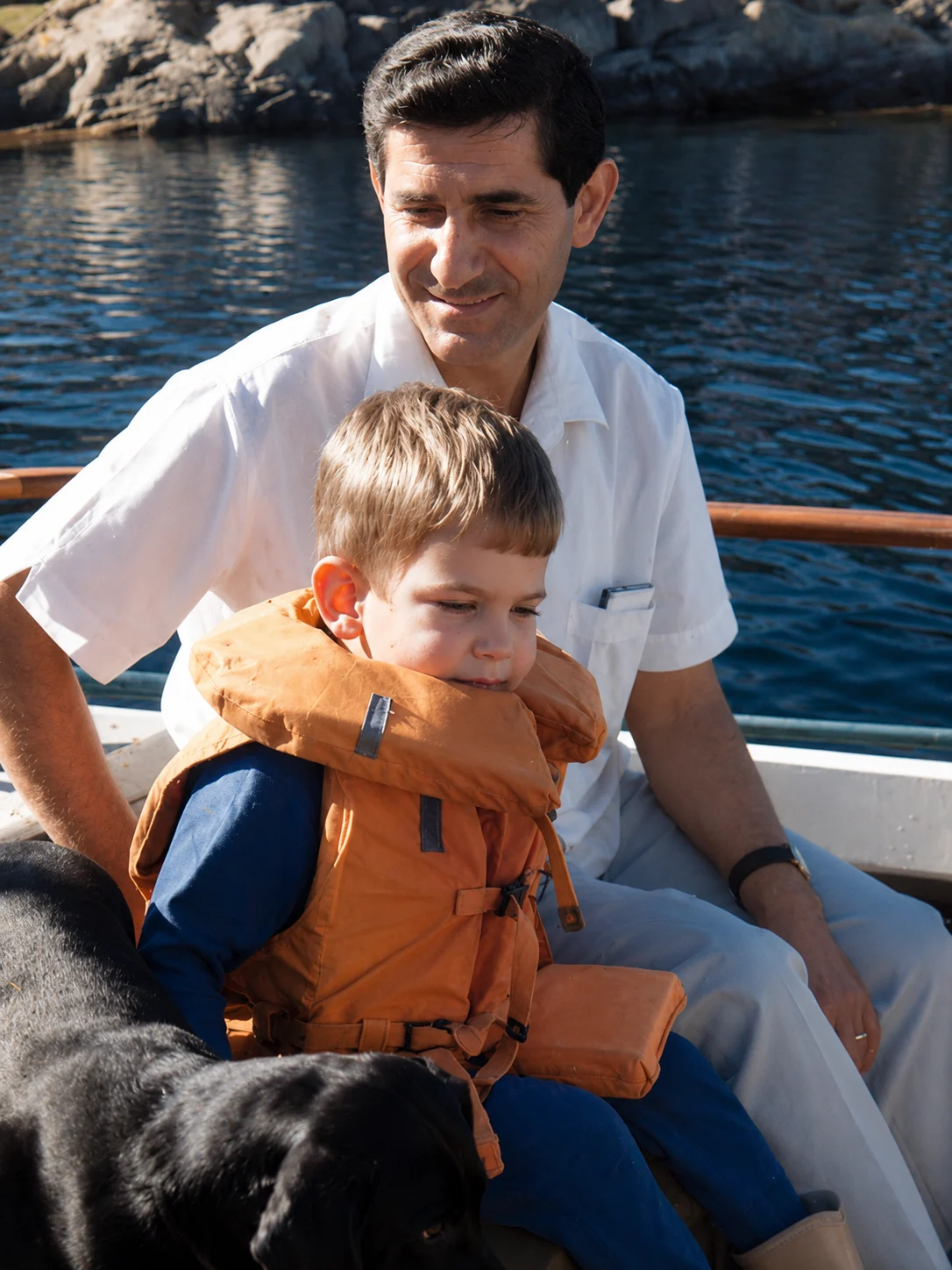 Judge Hassan Kawas sitting with a child on a boat