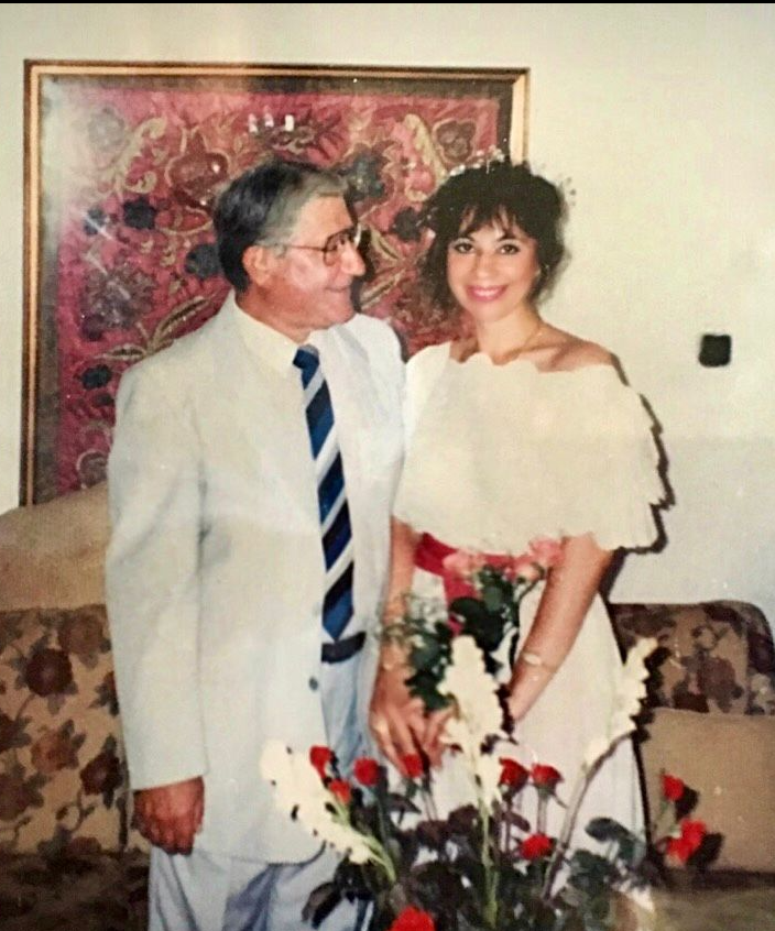 Judge Hassan Kawas standing with his wife Mirvat Salam in an indoor family photograph