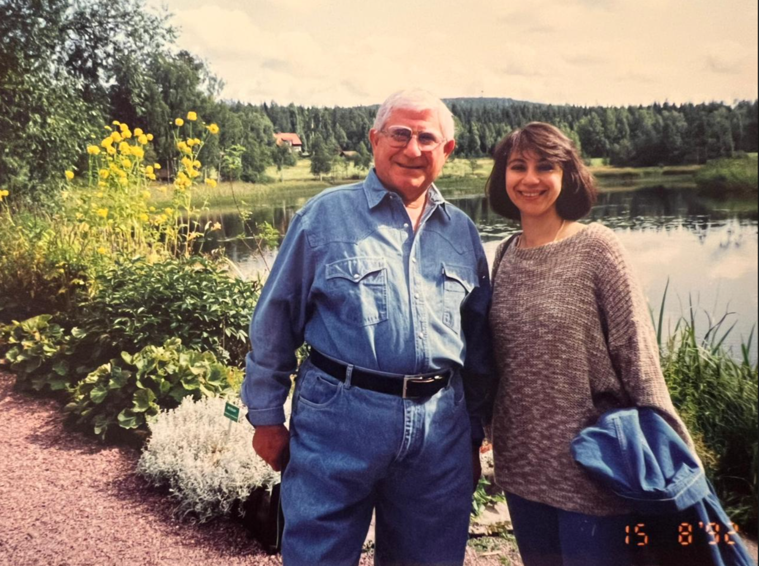 Judge Hassan Kawas standing with his wife Mirvat Salam by a lakeside landscape