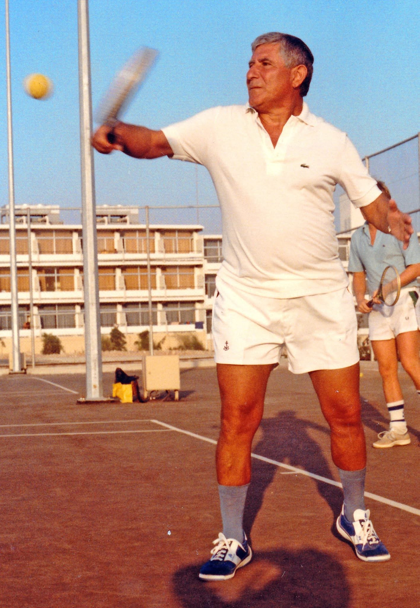 Judge Hassan Kawas playing tennis on an outdoor court